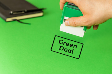 Green deal, European green deal environmental concept, Clerk puts an approving stamp with the words...