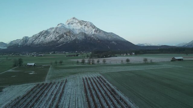 Scenic drone footage of the snowcapped Untersberg Mountain in Salzburg, Austria. Shot via drone in 4k at both sunrise and sunset. Along with the small town at the bottom of the mountain.