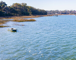 Small Boat Floating on Skull Creek at The Pope Squire Community Park, Hilton Head, South Carolina, USa