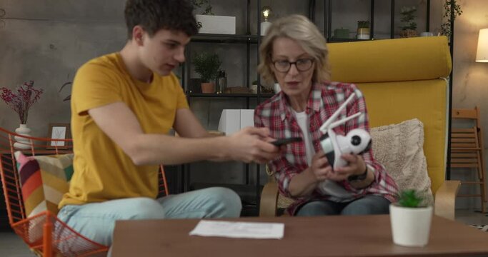 Mother and son adjust and install home cctv video surveillance camera