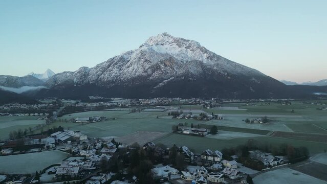 Scenic drone footage of the snowcapped Untersberg Mountain in Salzburg, Austria. Shot via drone in 4k at both sunrise and sunset. Along with the small town at the bottom of the mountain.