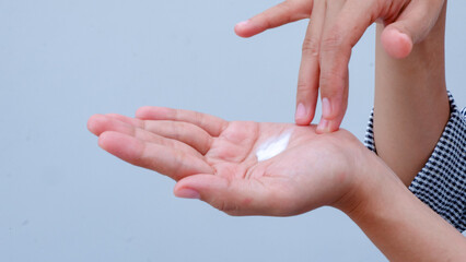 Close up of a woman hand skin applying cream.