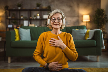 Mature blonde woman practice guided meditation manifestation at home