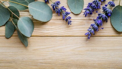 light wood background with some eucalyptus and lavender branches copy space 16 9