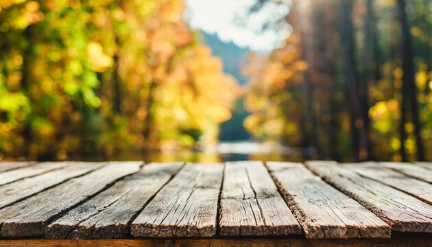 the empty rustic wooden table for product display with blur background of autumn forest exuberant image