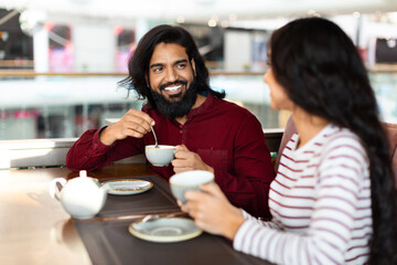 Cheerful young indian man enjoying date with his girlfriend