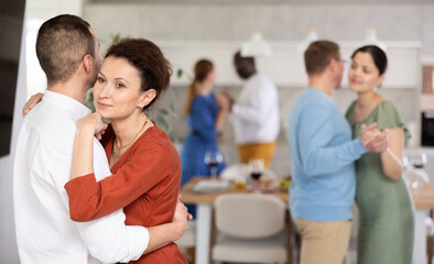 Multicultural couples of men and women dancing slow couple dances