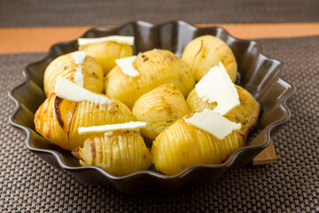Hasselback potatoes with butter - 761843188