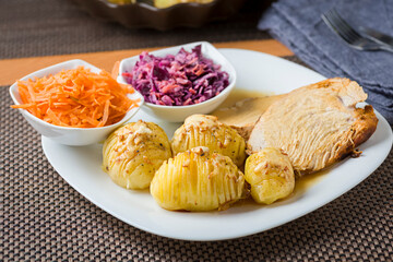 baked hasselback potatoes served with baked fillet and salad - 761843198