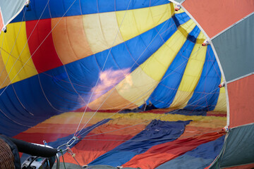 Obraz premium View inside a hot air balloon with flame during inflation