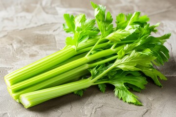 Bunch of fresh celery on a gray concrete background