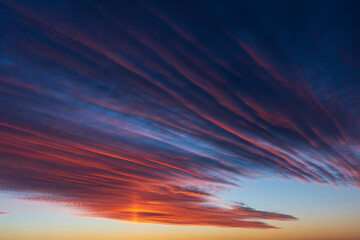 Stunningly beautiful multi-colored violet-pink-lilac evening sky, multi-colored clouds fan out from the lower horizon