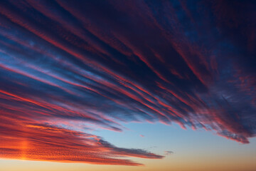 Stunningly beautiful multi-colored violet-pink-lilac evening sky, multi-colored clouds fan out from...