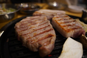 Grilled pork belly on the grill in the restaurant