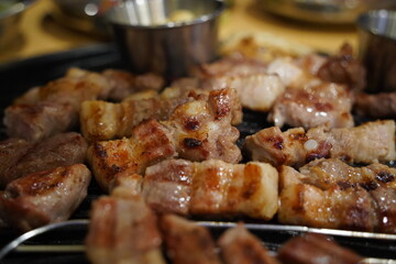 Grilled pork belly on the grill in the restaurant