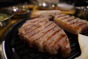 Grilled pork belly on the grill in the restaurant