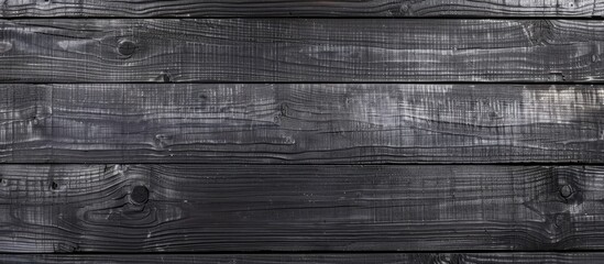 A detailed shot of a grey wooden wall with tints and shades, showcasing a beautiful pattern of...