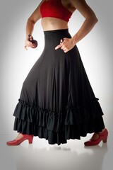 Flamenco dancer from the waist to shoes with castanets isolated on white background.