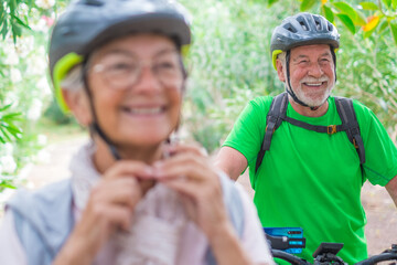 One old mature man riding a bike and enjoying nature outdoors having fun. Senior having a healthy and fit lifestyle..