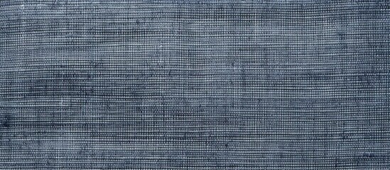 A close up of a grey denim flooring tile with a font pattern in a parallel electric blue rectangle, showcasing symmetry and texture