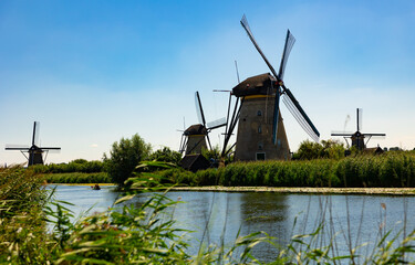 Naklejka premium System of ancient windmills used for draining water from Kinderdijk polder soil into river, Netherlands