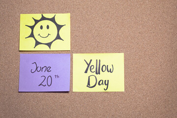 Corkboard with sticky notes for Yellow Day, June 20. The happiest day of the year.