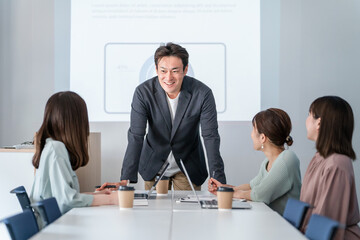 オフィス・会議室で会議・ミーティング・打ち合わせするビジネスマンとビジネスウーマン
