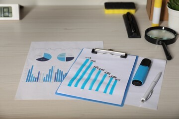 Business process planning and optimization. Workplace with different graphs and other stationery on...