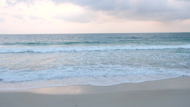 Ocean waves roll on the sand.