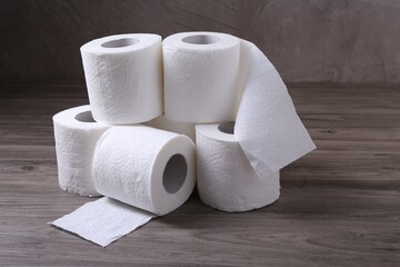 Soft toilet paper rolls on wooden table