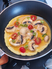 Fried omellette with mushroom, cherry tomatoes, spring onion or Telur dadar in Indonesia