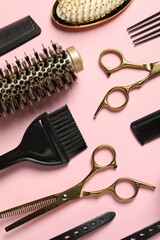 Professional hair dresser tools on pink background, flat lay