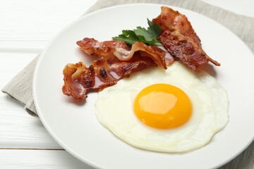 Delicious breakfast with sunny side up egg on white wooden table, closeup