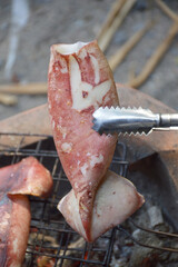 close up grilled squid on stove