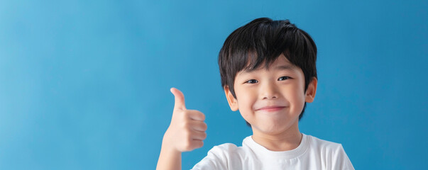 Happy Asian school boy giving thumbs up