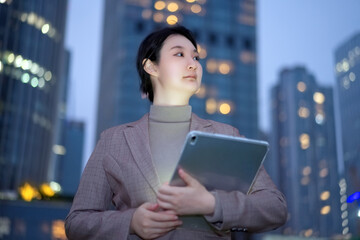 Confident Businesswoman Using Tablet in Urban Setting