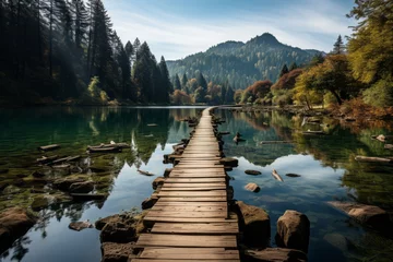 Gordijnen Wooden bridge over water in natural landscape with trees and mountains © Yuchen Dong