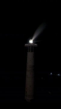 Jandia lighthouse at night aerial drone shot circling	
