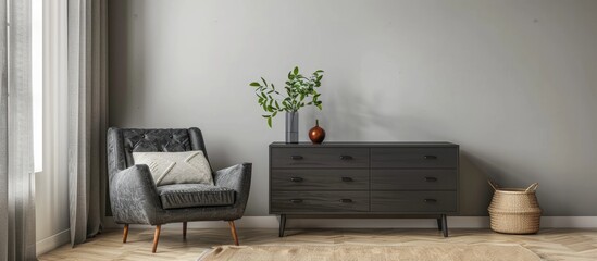 Dark grey armchair with rug, dresser and pillow by light-colored wall
