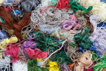 Abstract background made of tangled multi-colored threads