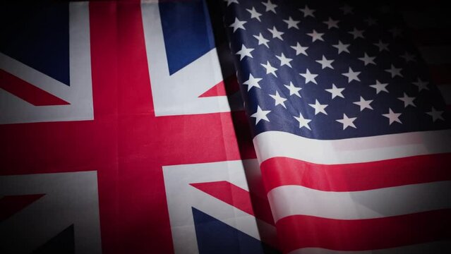 United States and Great Britain flags on turntable on dark background