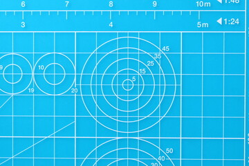 blue cutting mat board background with line and scale measure guide pattern for object art design, tool equipment of diy craft work