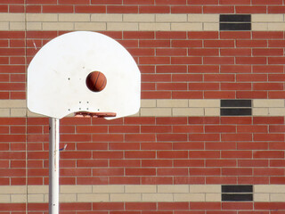A basketball suspended in time, just before its trajectory toward the solid rim of the scoring...