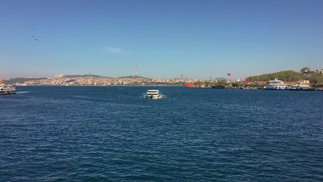 A ferry in Istanbul cruising the Bosporus on a sunny day.