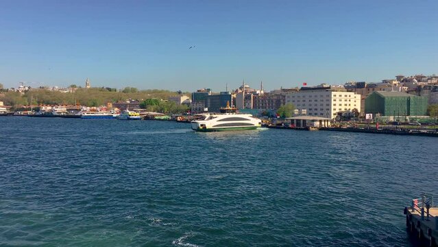 A ferry in Istanbul cruising the Bosporus on a sunny day.