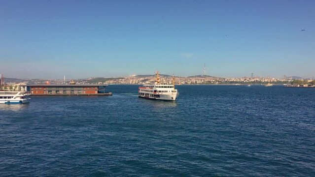 A ferry in Istanbul cruising the Bosporus on a sunny day.
