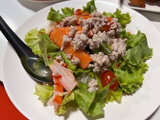 Traditional Spicy minced pork and fresh vermicelli salad serving on the plate. Famous appetizer and starter menu in local restaurant.