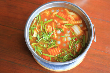 Thai sour soup with ryukyu fish egg and vegetable in bowl on wooden table. Gaeng Som RyoSyo egg. - 761953136