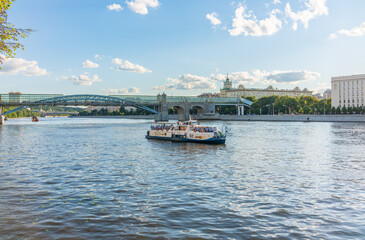 View of the Moscow river embakment, Pushkinsky bridge and cruise ships at sunset.