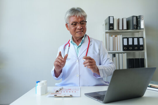 Senior doctor with stethoscope sitting in medical office, treating, recommending medicine. Method of practice Care via laptop Online video calls with patients service concept Disease care.